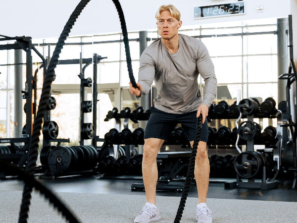 Person using PowerBlock Battle Rope at the gym.