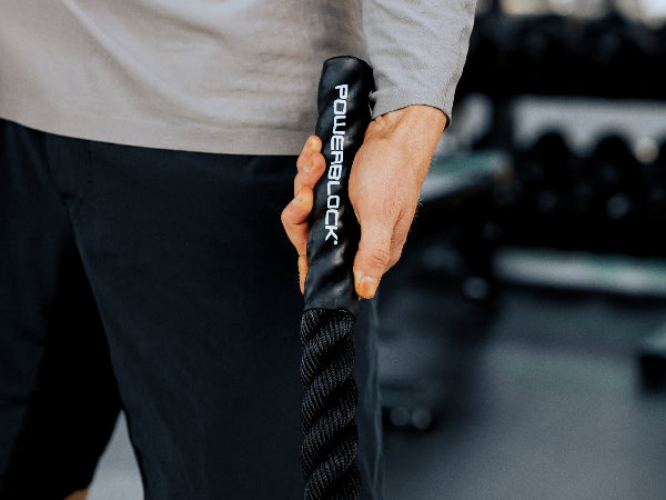 Close-up of Battle Rope being used with the PowerBlock logo.