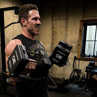 Don Saladino doing a bicep curl with PowerBlock Pro 100 Adjustable Dumbbells.