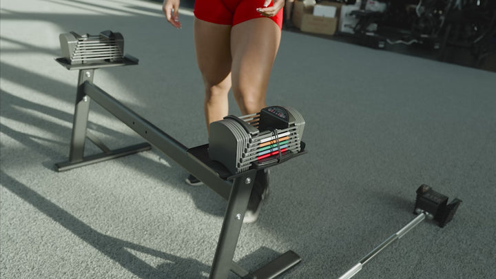 PowerBlock Sport 24 adjustable dumbbells being used as an adjustable barbell with a compatible barbell attachment