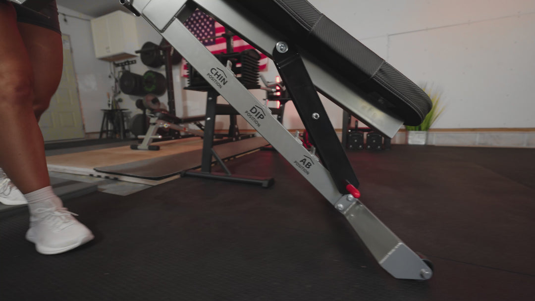 A women demonstrating the PowerBlock Sport-bench and its compatible attachments. The Chin-up and Pull-up, Ab, and Dip attachments.