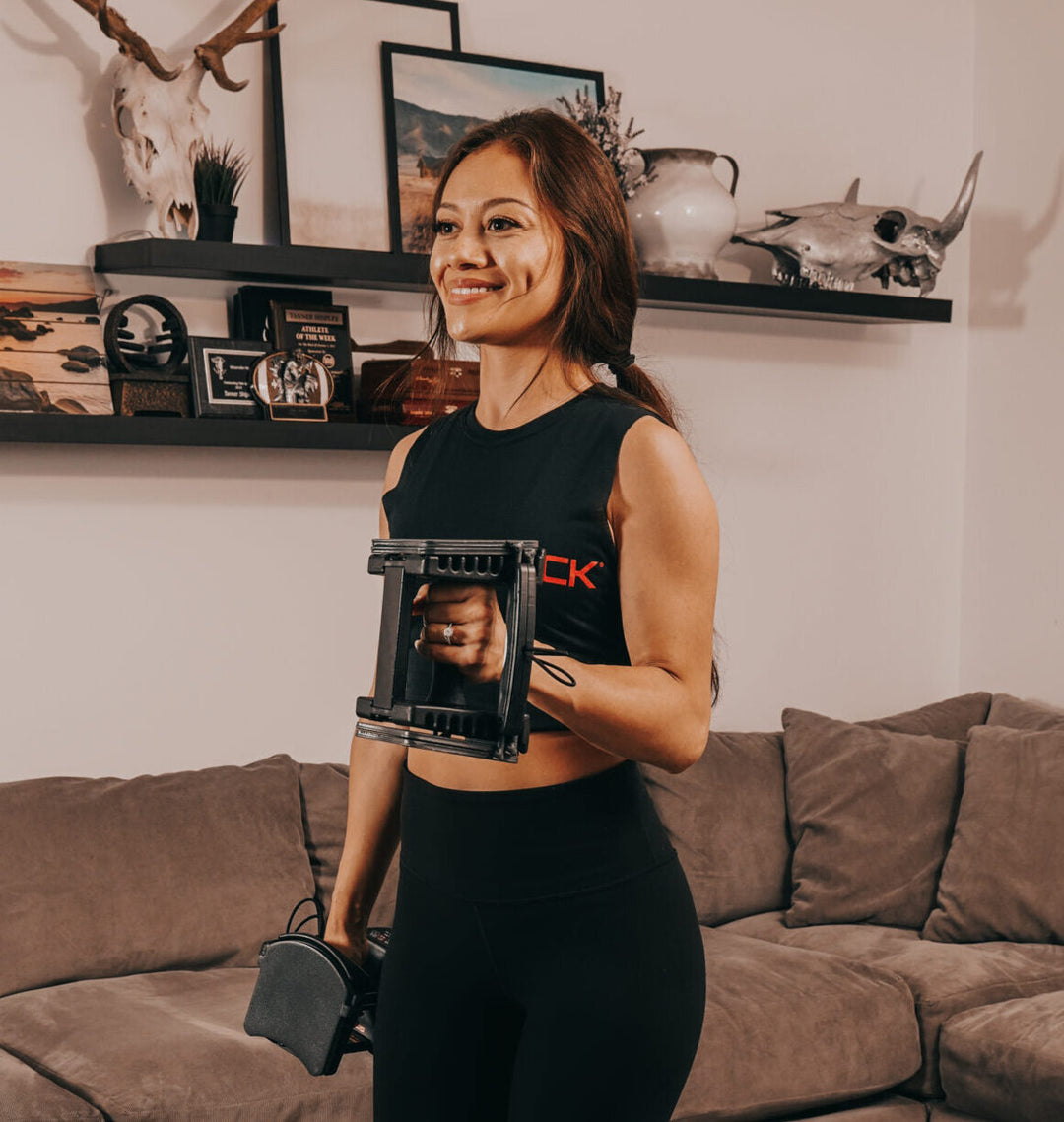 a woman performs an adjustable dumbbell hammer curl 