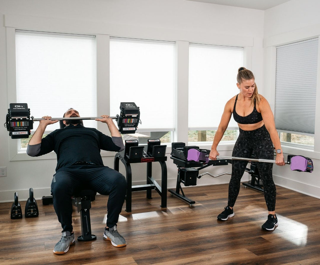 Man and women training using the PowerBlock Ecosystem of products. 