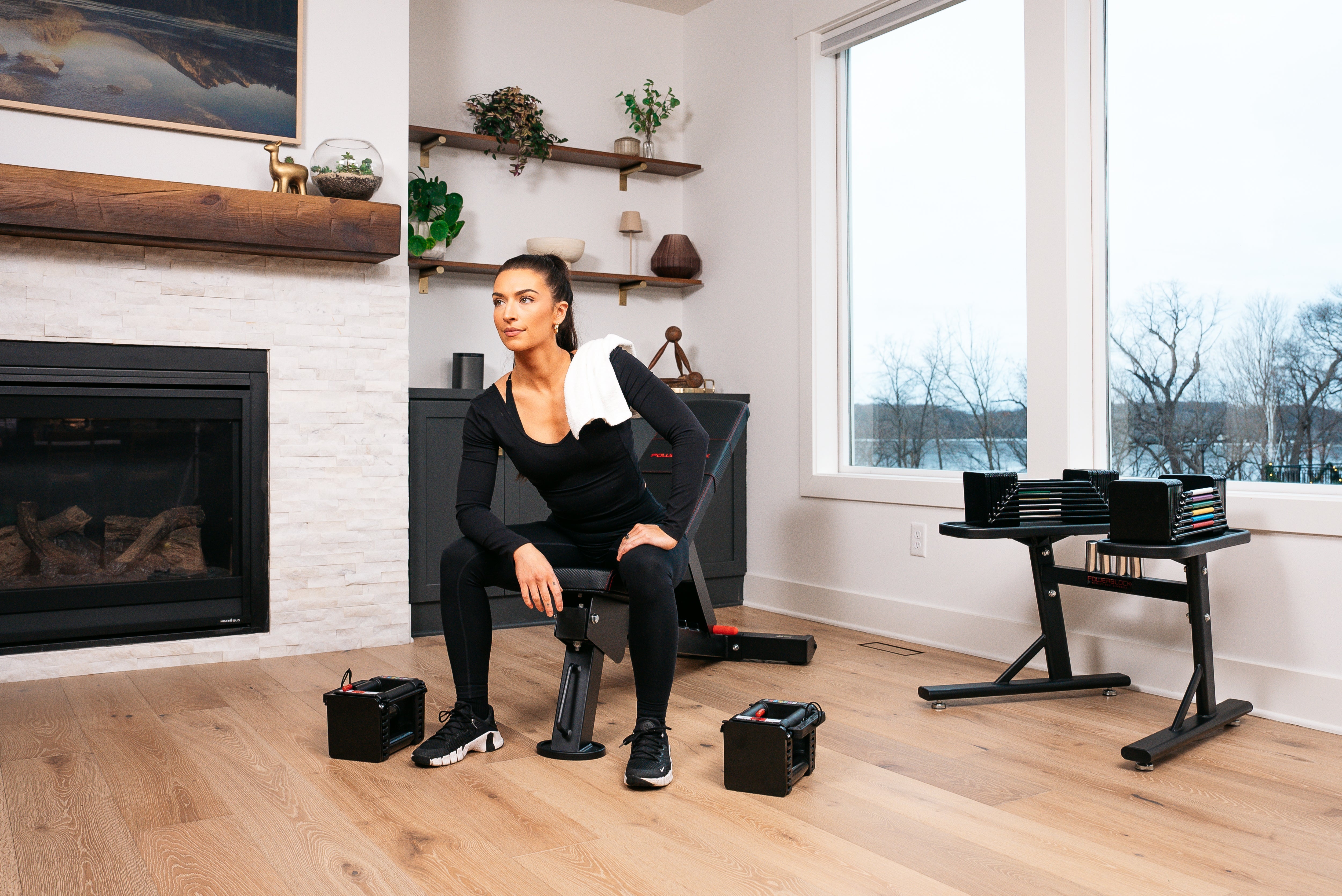 Woman Resting Between sets using the PowerBlock Elite USA 90 Adjustable Dumbbell and the PowerBench 2.0