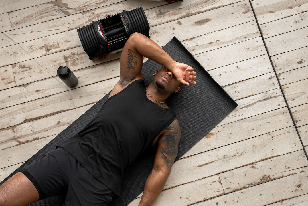 an athlete taking a break on a workout mat