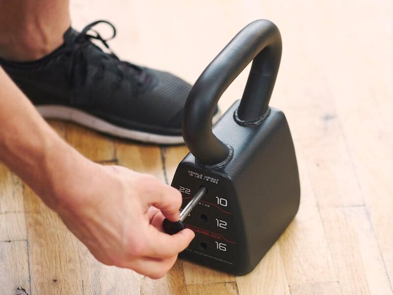 weight being selected on a PowerBlock adjustable kettlebell