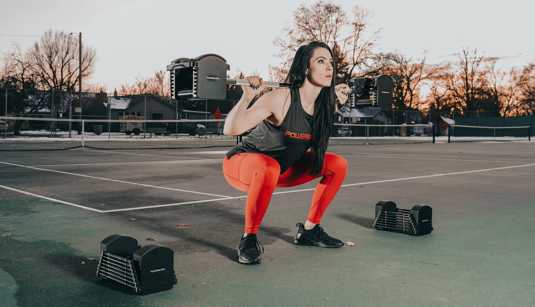 Squatting with PowerBlock Pro Series Straight Bar and Pro 50 Adjustable Dumbbells.