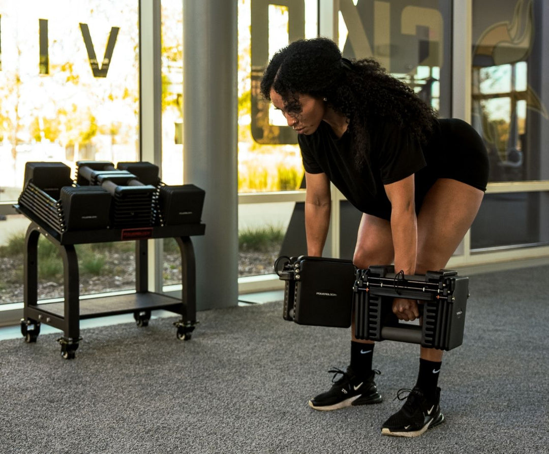 Woman doing deadlifts using the  Commercial Pro 175 Dumbbells  
