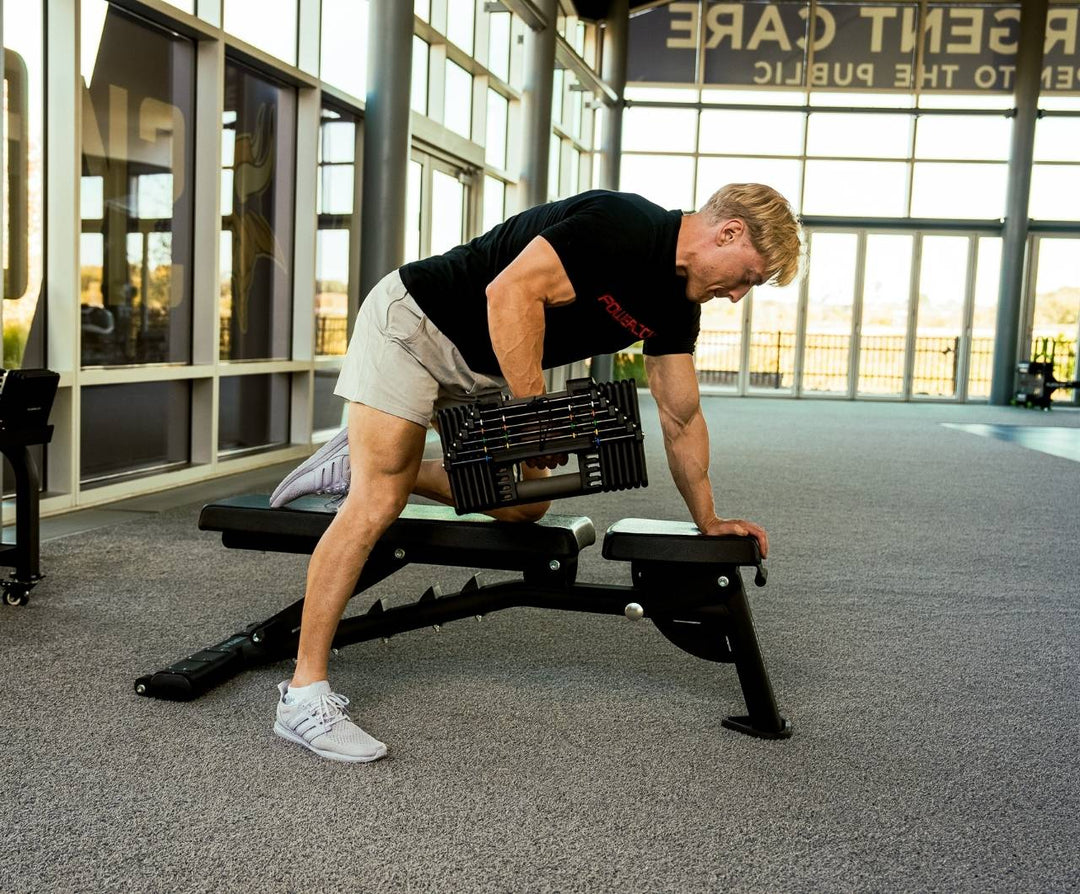 Man lifting Commercial Pro 175 Dumbbells on PowerBench 