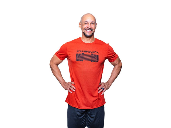 Man wearing a Desert Sun Mens Tee that features a black PowerBlock Dumbbell.