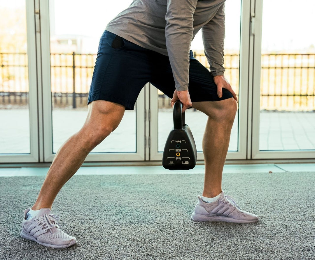 Man doing heavy kettlebell rows