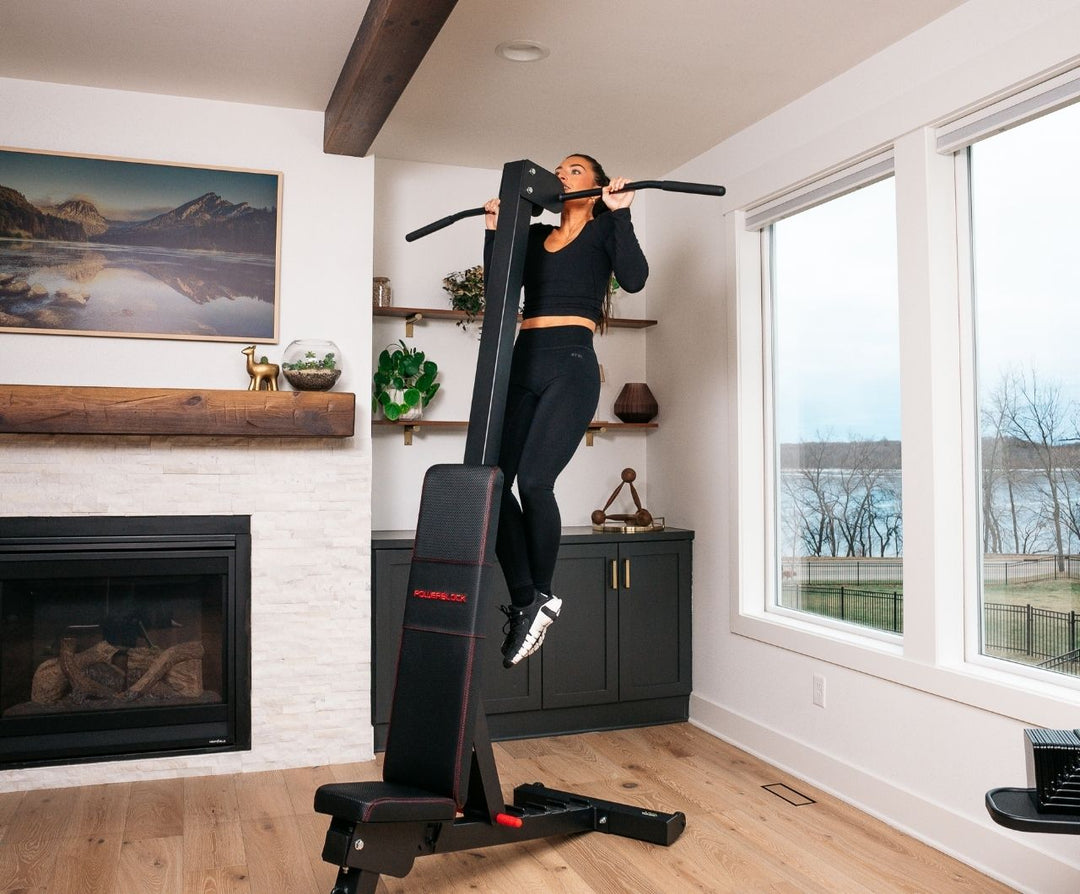 Woman using the powerbench 2.0 chin-up attachment