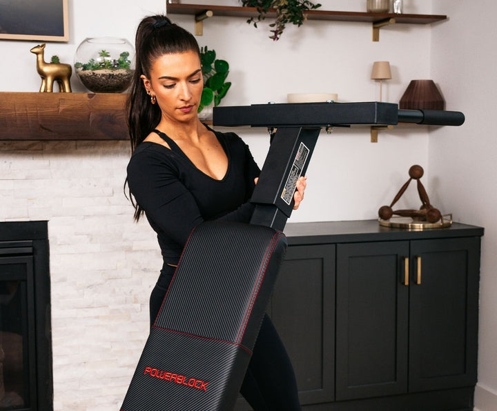Woman setting up the PowerBench 2.0 dip attachment