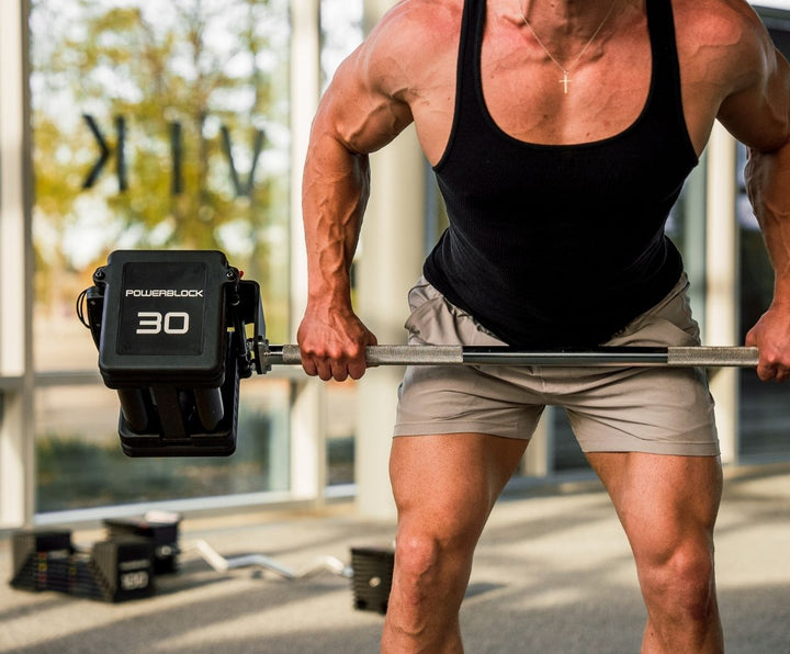 Close up of a man curling the Pro 100 Straight Bar