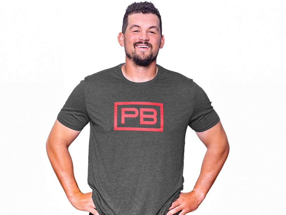 Man wearing a Space Black PowerBlock Mens Tee that features a red PB logo.