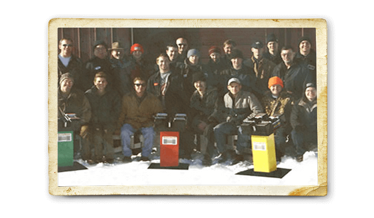 A throwback image of origional PowerBlock users/team posed with three PowerBlock dumbbell racks