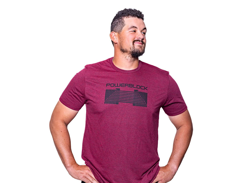 Man wearing a Vino Red Mens Tee that features a black PowerBlock Dumbbell.