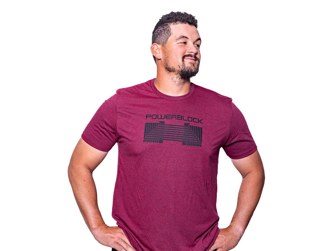 Man wearing a Vino Red Mens Tee that features a black PowerBlock Dumbbell.