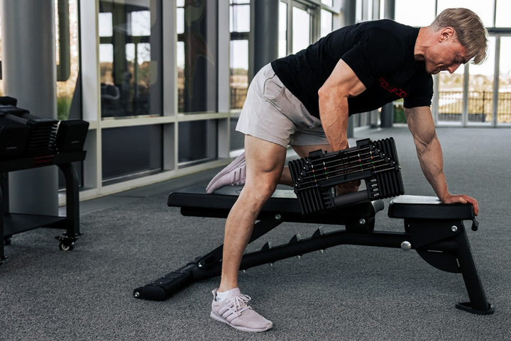 Man doing row with PowerBlock Commercial Adjustable Dumbbell.