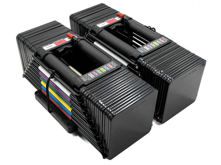 PowerBlock Elite USA 90 adjustable dumbbells shown with all expansion stages at the full weight of 90 pounds.