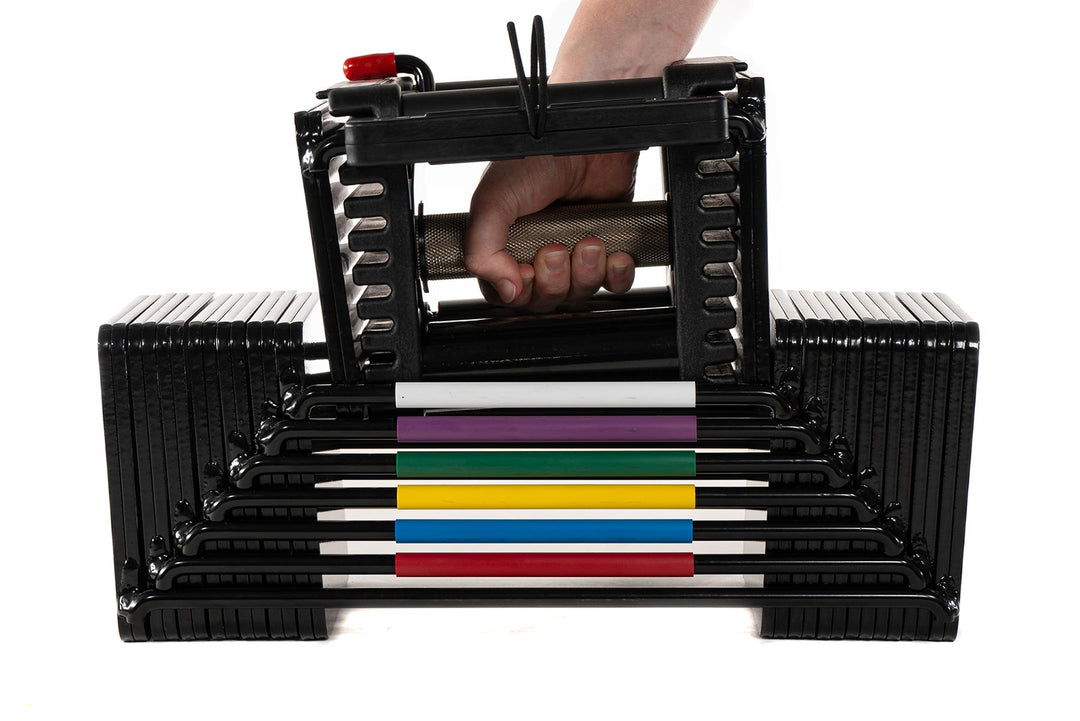 PowerBlock Elite USA adjustable dumbbell handle with a knurled grip being lifted up out of the core weight stack at a light weight, detail view showing a medium knurl