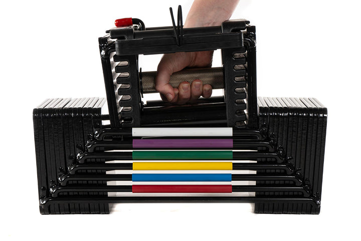 PowerBlock Elite USA adjustable dumbbell handle with a knurled grip being lifted up out of the core weight stack at a light weight, detail view showing a medium knurl