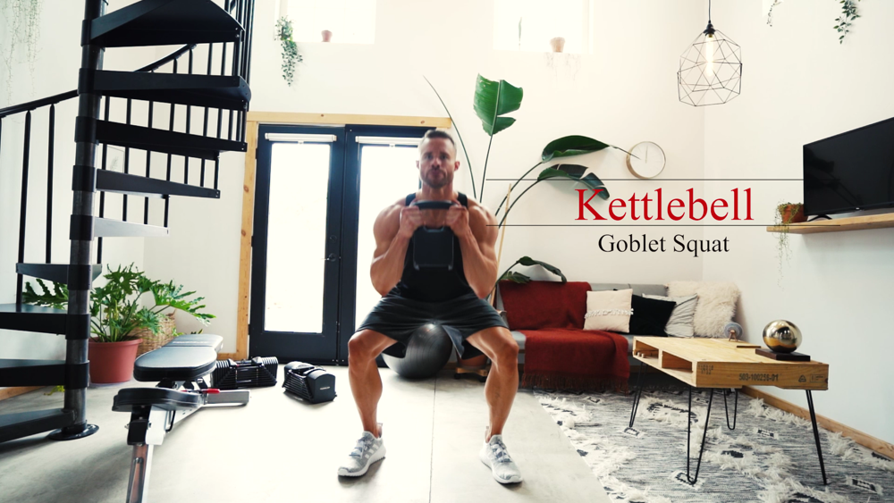 A man doing goblet squats with a PowerBlock adjustable kettlebell