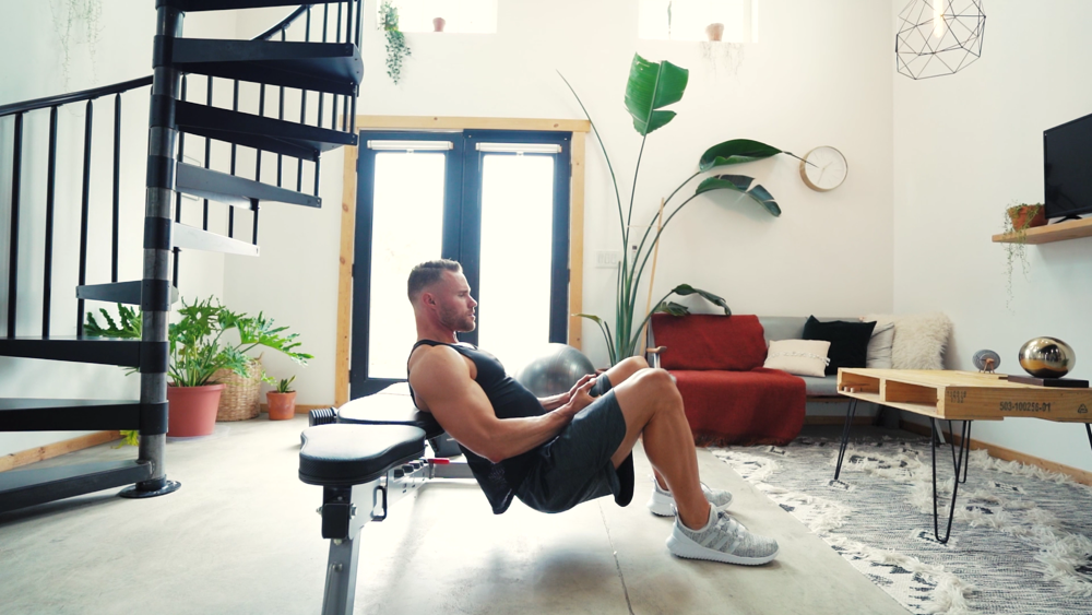 A man doing hip thrusts with a PowerBlock bench and Powerblok adjustable kettlebell