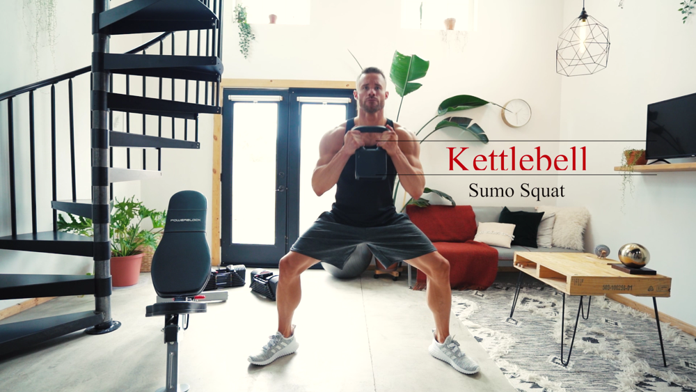 A man doing a sumo squat with a PowerBlock adjustable kettlebell