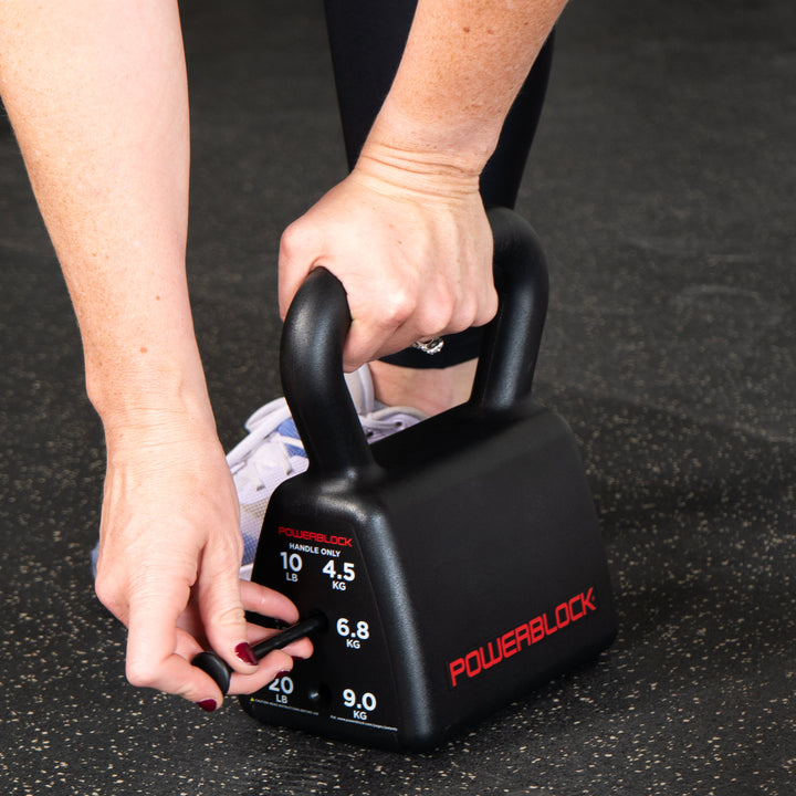 Flex pin selector being inserted into the PowerBlock Sport Adjustable Kettlebell