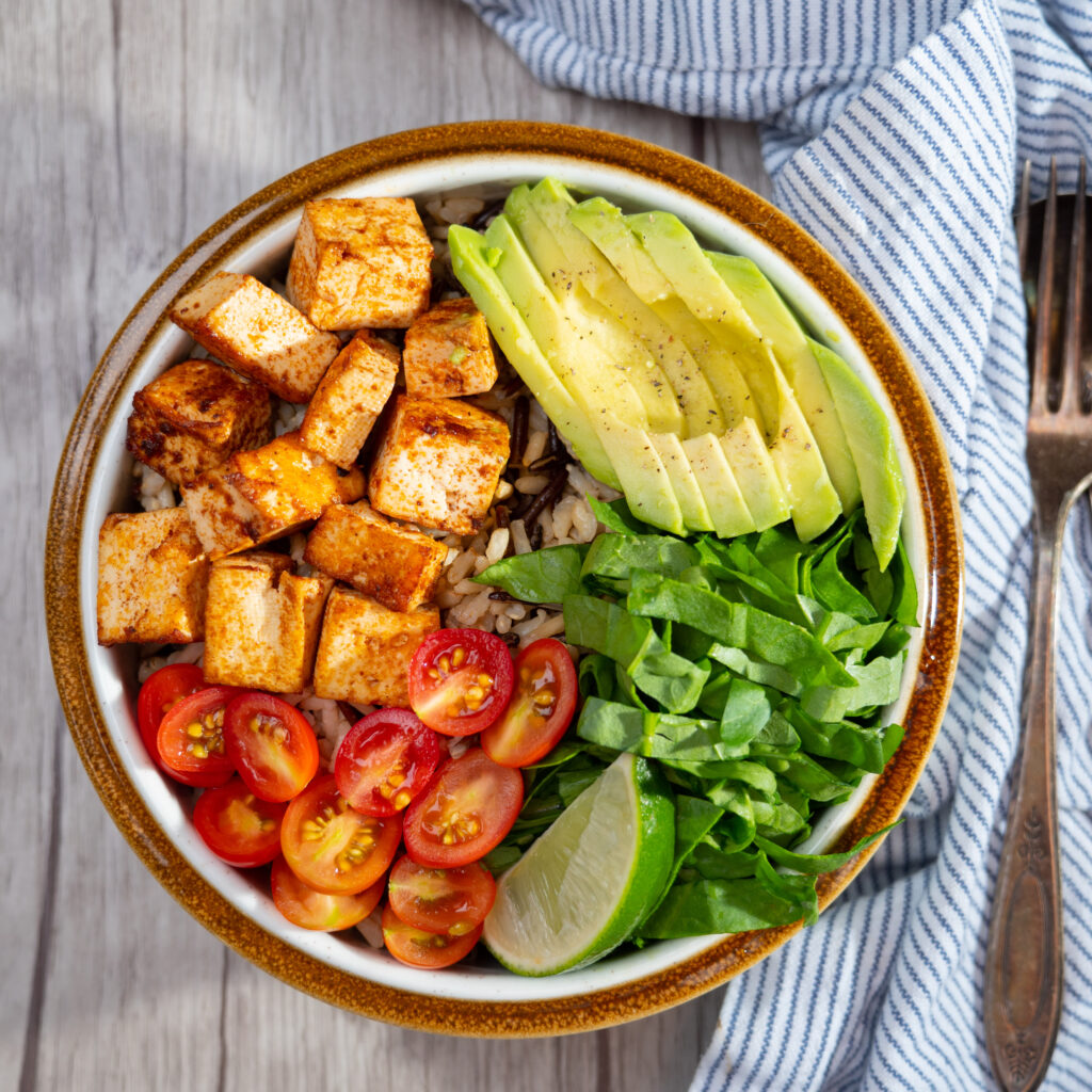 A look at a Power Bowl. This one features lettuce, lime, avocado, tomatoes, tofu and rice.