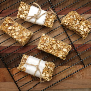 5 granola bars resting on a baking rack