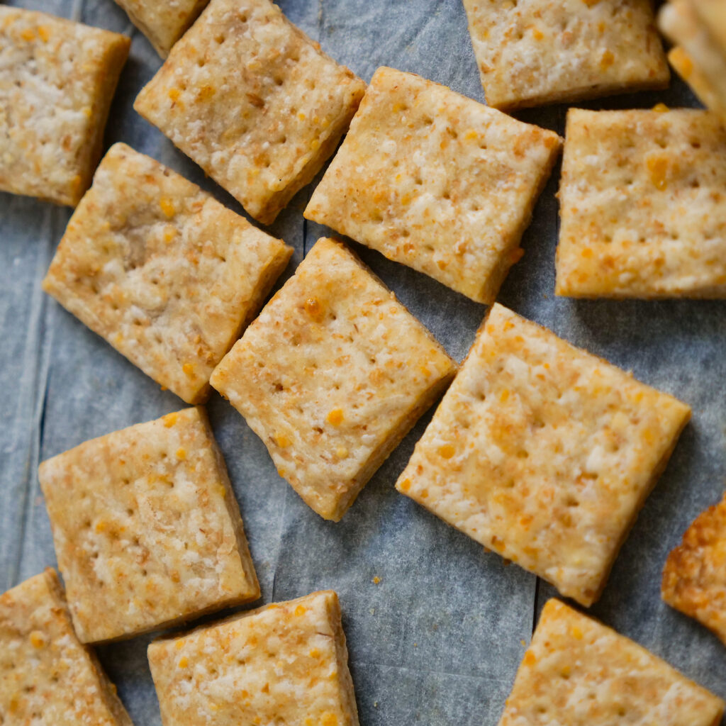 many homemade crackers laid out on a cloth napkin
