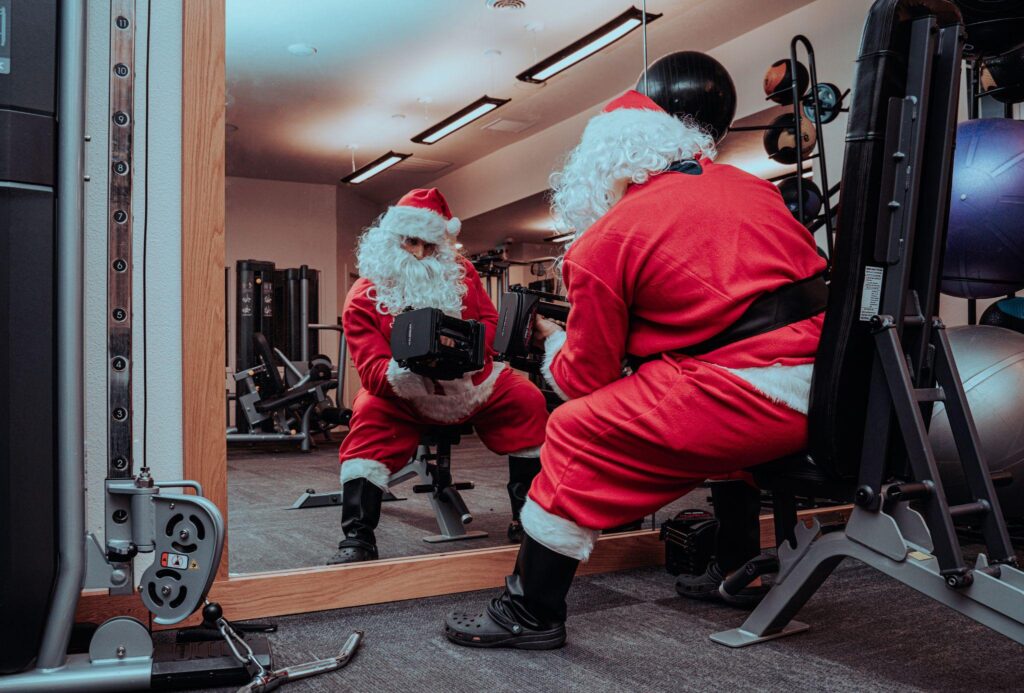 Santa Claus works out in his home gym, using PowerBlock adjustable dumbbells.